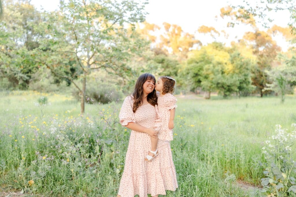 a mom and daughter in matching dresses during a mothers day photo session in Costa Mesa, California