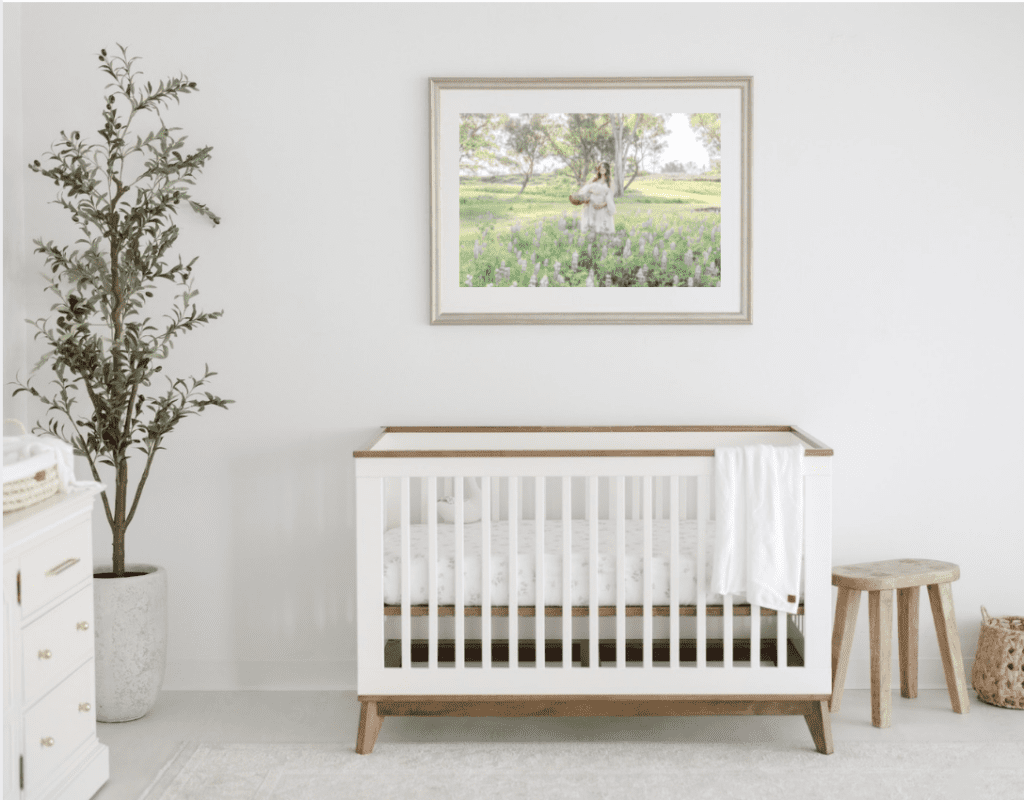 A nursery where Erin Custer photo took the photo that is on the wall of a mom in a lupine field for maternity photos 
