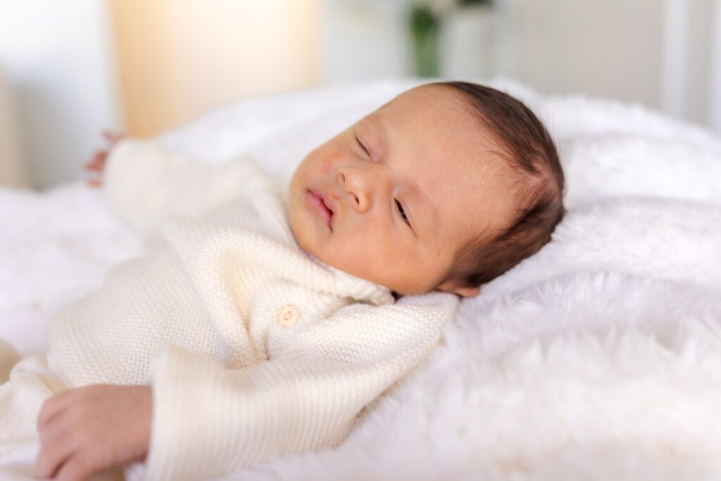mother cradling her newborn at Spark Studios in Huntington Beach during a done-for-you luxury photography session