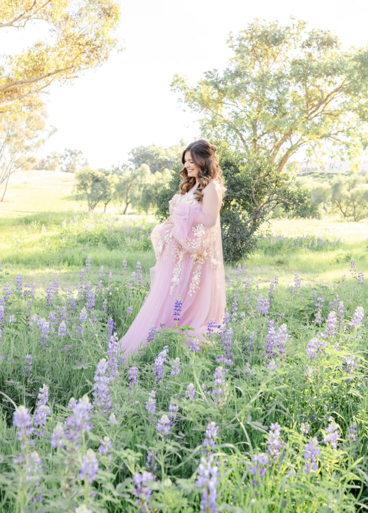 Luxury maternity photography session  featuring a lupine field for a pregnant mom