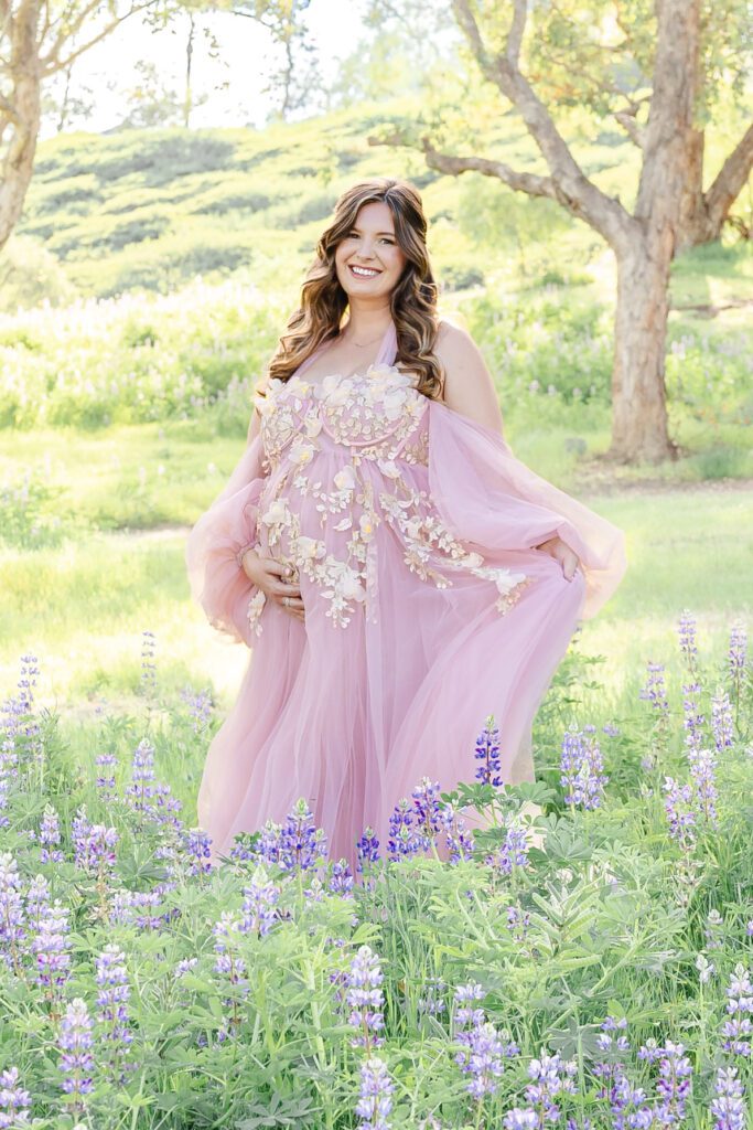 Luxury maternity photography session  featuring a lupine field for a pregnant mom