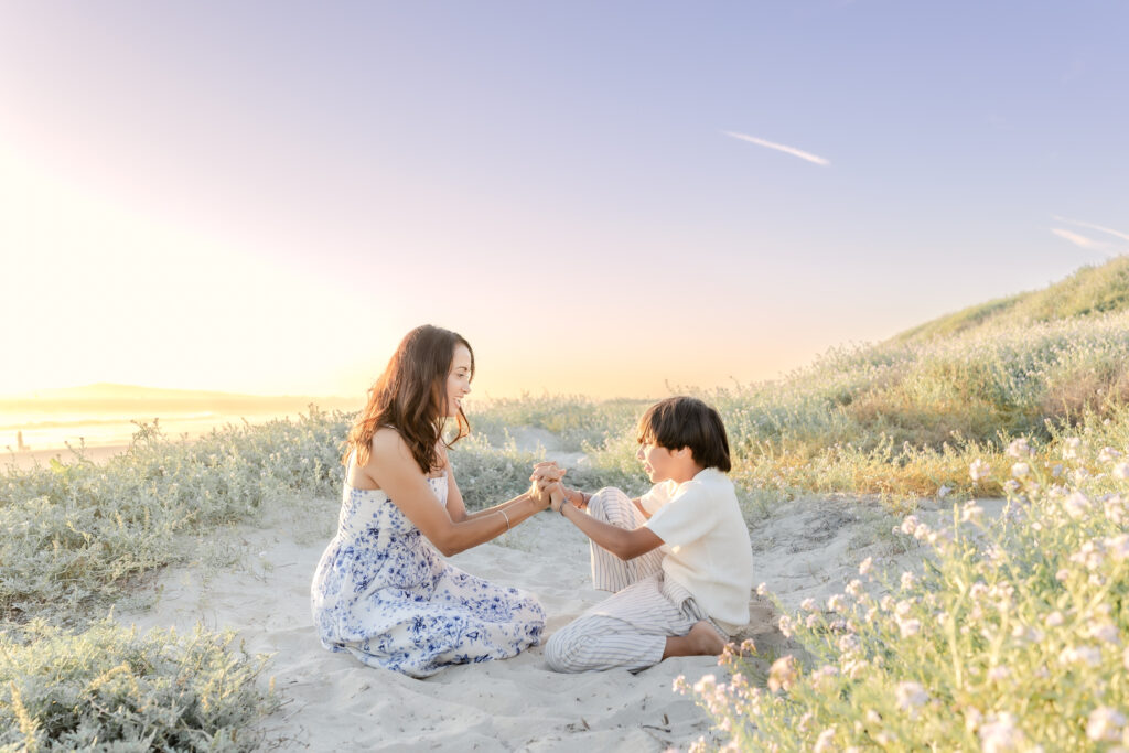a mother and son holding hands in Huntington Beach 
