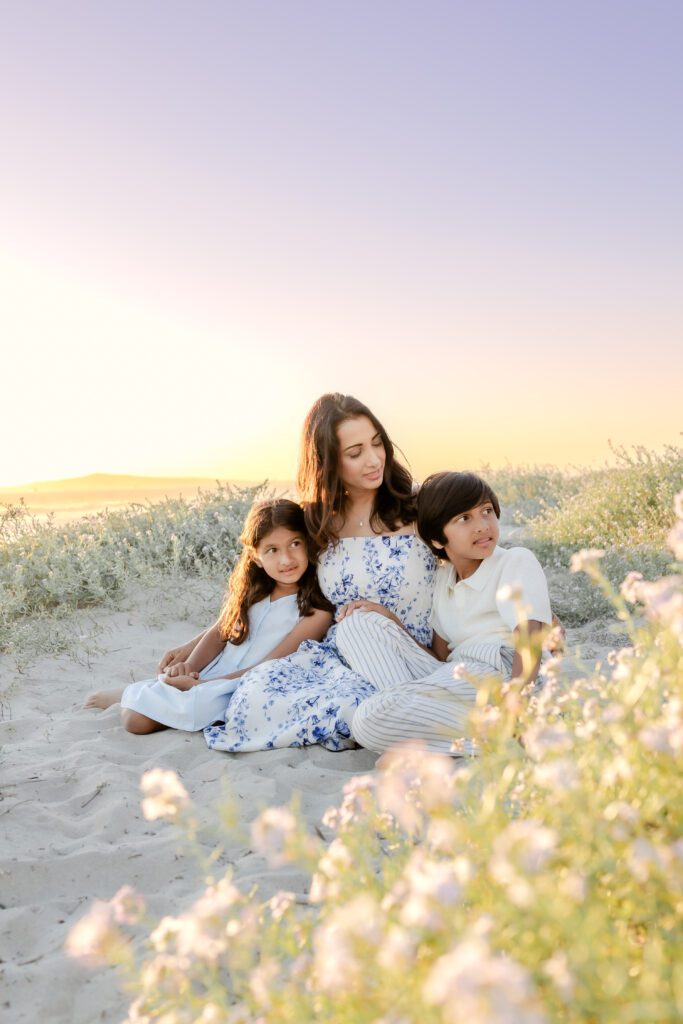 a mother and children on the beach in Huntington Beach