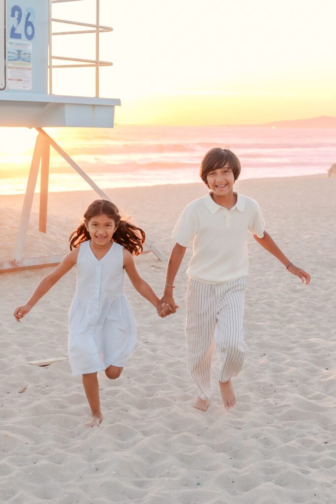 brother and sister running in Huntington Beach