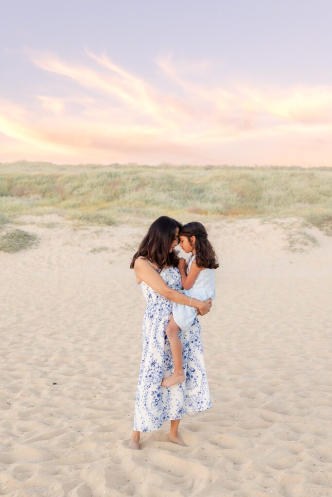 mother and daughter hugging on the beach in Huntington Beach
