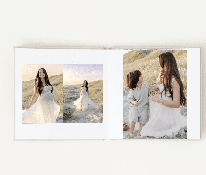 Open heirloom album displaying fine art motherhood prints, styled with linen and florals in Southern California