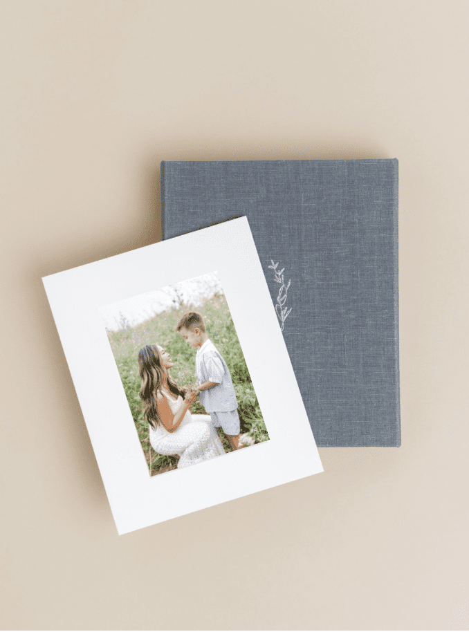 Velvet heirloom album and matted print box, styled flat-lay by a Southern California luxury family photographer