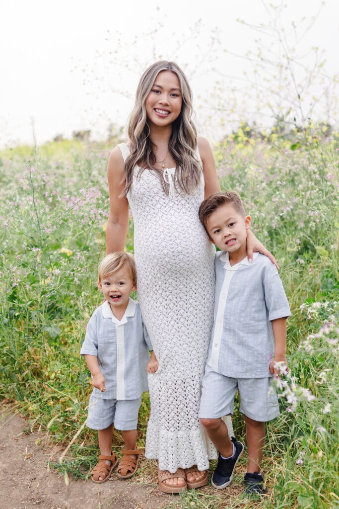Summer maternity session with mom and her two sons in a flower field 